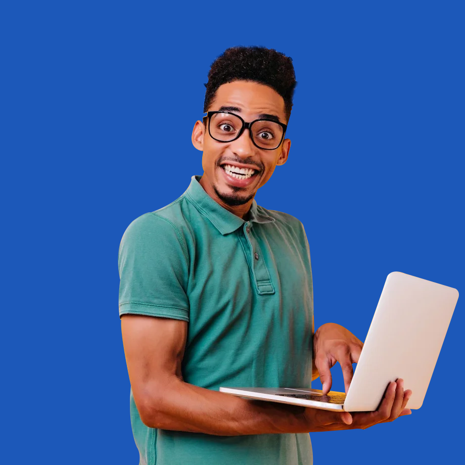 Man wearing glasses and a green shirt, smiling while using a laptop, showing satisfaction with managing recurring payments